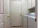Laundry room featuring a white washer and dryer set and doorway access at 338 Brilliant Summit Cir, Henderson, NV 89052