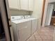 Convenient laundry area equipped with a washer and dryer, plus overhead cabinets at 338 Brilliant Summit Cir, Henderson, NV 89052
