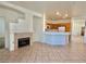 Bright living room showcasing tile floors, a fireplace, and open access to kitchen at 338 Brilliant Summit Cir, Henderson, NV 89052