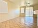 Neutral living room with tiled floor, ceiling fan, and sliding glass doors to backyard at 338 Brilliant Summit Cir, Henderson, NV 89052