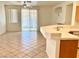 Open concept living space featuring tile floors, a ceiling fan, and access to the backyard at 338 Brilliant Summit Cir, Henderson, NV 89052