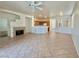 Open-concept living room with tile flooring, fireplace and bar seating to kitchen at 338 Brilliant Summit Cir, Henderson, NV 89052