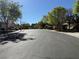 Scenic residential street with lush trees, manicured lawns, and sidewalks at 338 Brilliant Summit Cir, Henderson, NV 89052
