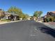 Wide, quiet residential street lined with mature trees and well-maintained homes at 338 Brilliant Summit Cir, Henderson, NV 89052