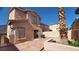 Exterior view of a home with a large sliding door leading to a private patio, a large palm tree at 37 Belle Soleil Ave, Las Vegas, NV 89123
