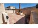 Private, shaded backyard patio featuring decorative pavers, rock landscaping, and block perimeter wall at 37 Belle Soleil Ave, Las Vegas, NV 89123