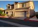 Charming stucco home featuring a two-car garage, manicured landscaping and a warm, inviting atmosphere at 37 Belle Soleil Ave, Las Vegas, NV 89123