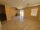 Bright living room with tile floors, ceiling fan, and sliding glass door at 37 Belle Soleil Ave, Las Vegas, NV 89123