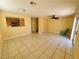 Spacious living room featuring tile flooring, ceiling fan, and view into the kitchen at 37 Belle Soleil Ave, Las Vegas, NV 89123