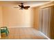 Bright living room with tile floors, a modern ceiling fan, and sliding glass doors to a patio at 37 Belle Soleil Ave, Las Vegas, NV 89123