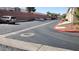 Well-maintained parking area for residents features red rock landscaping and mature plantings at 37 Belle Soleil Ave, Las Vegas, NV 89123