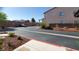 Exterior parking area features red rock landscaping, a wall, and mature plantings at 37 Belle Soleil Ave, Las Vegas, NV 89123
