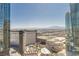 Wide city view from a high-rise building showcasing nearby structures, pools, and distant mountains at 3722 Las Vegas Blvd # 3209, Las Vegas, NV 89158