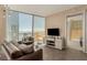 Modern living room featuring stylish furnishings, sleek entertainment center, and panoramic city views through expansive windows at 3722 Las Vegas Blvd # 3209, Las Vegas, NV 89158