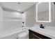 Modern bathroom with dark wood vanity and an illuminated mirror at 3944 Visby Ln, Las Vegas, NV 89119