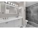 Modern bathroom boasts double sinks, vanity, and a tiled walk-in shower at 3944 Visby Ln, Las Vegas, NV 89119