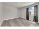 Neutral bedroom features wood-look flooring, bright light from a window, and crisp, white trim at 3944 Visby Ln, Las Vegas, NV 89119
