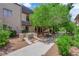 Exterior view of condo with mature landscaping and sidewalk at 3944 Visby Ln, Las Vegas, NV 89119