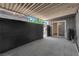 Covered patio with a grey textured floor and a privacy wall at 3944 Visby Ln, Las Vegas, NV 89119