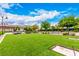 Expansive community lawn provides ample space for recreation and relaxation, featuring lush greenery and shaded seating areas at 412 Middlestone Ave, Henderson, NV 89011