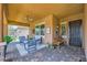 Cozy covered patio featuring comfortable seating, a ceiling fan, and a welcoming ambiance at 412 Middlestone Ave, Henderson, NV 89011