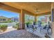 Relaxing covered patio furnished with comfortable seating, offering a tranquil outdoor living space at 412 Middlestone Ave, Henderson, NV 89011