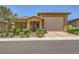 Charming single-story home showcasing desert landscaping and a warm, inviting entrance, complete with a two-car garage at 412 Middlestone Ave, Henderson, NV 89011