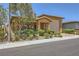 Inviting single-story residence featuring a well-manicured yard, covered porch, and an attached two-car garage at 412 Middlestone Ave, Henderson, NV 89011
