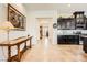 Inviting hallway with console table and elegant painting leading to modern kitchen with sleek, dark cabinets at 412 Middlestone Ave, Henderson, NV 89011
