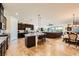 Expansive open floor plan with a kitchen island, stainless steel appliances, dining area, and cozy living space at 412 Middlestone Ave, Henderson, NV 89011