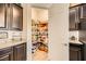 Walk-in pantry with shelving stocked with goods, open next to granite countertop at 412 Middlestone Ave, Henderson, NV 89011