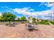 Inviting patio area with comfortable seating and tables, perfect for outdoor dining and socializing amidst well-manicured landscaping at 412 Middlestone Ave, Henderson, NV 89011