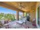 Relaxing covered patio boasts a ceiling fan, comfortable seating, and stylish decor, perfect for enjoying the outdoors at 412 Middlestone Ave, Henderson, NV 89011