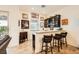Wet bar with dark cabinetry, granite counters, seating, and decor at 412 Middlestone Ave, Henderson, NV 89011