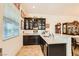 Wet bar with granite counters, dark cabinetry, and seating area at 412 Middlestone Ave, Henderson, NV 89011