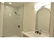 Updated bathroom vanity featuring a modern arched mirror and sleek black faucet at 4277 Rimcrest Rd, Las Vegas, NV 89121