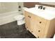 Chic bathroom showcases sleek black floor tiles and a wood vanity with black hardware at 4277 Rimcrest Rd, Las Vegas, NV 89121