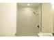 Modern bathroom featuring tiled shower with rainfall showerhead and sleek black fixtures at 4277 Rimcrest Rd, Las Vegas, NV 89121