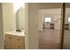 Bathroom featuring an updated vanity, mirror and doorway leading to kitchen at 4277 Rimcrest Rd, Las Vegas, NV 89121