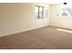 Neutral bedroom featuring plush carpet, a window, and white door at 4277 Rimcrest Rd, Las Vegas, NV 89121