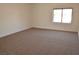 Bright bedroom with neutral carpet, white walls, and a window providing natural light at 4277 Rimcrest Rd, Las Vegas, NV 89121