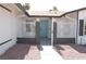Welcoming front entrance with secure white iron gates and a vibrant blue door at 4277 Rimcrest Rd, Las Vegas, NV 89121