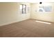 Bright, freshly painted room featuring new carpets and multiple windows for natural light at 4277 Rimcrest Rd, Las Vegas, NV 89121