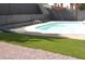 Inviting backyard pool with artificial turf and well-kept gravel, fenced for privacy at 4277 Rimcrest Rd, Las Vegas, NV 89121