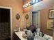 Bathroom vanity featuring double sinks, large mirrors and decorative elements at 4620 Ventana Rey St, North Las Vegas, NV 89081