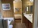 This bathroom features dual sinks, beautiful wallpaper, and a soaking tub at 4620 Ventana Rey St, North Las Vegas, NV 89081