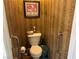 Small bathroom with a toilet, grab bars, and striped wallpaper at 4620 Ventana Rey St, North Las Vegas, NV 89081