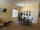 This spacious dining room features tan carpet, a chandelier, and space to entertain at 4620 Ventana Rey St, North Las Vegas, NV 89081