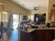 A casual living room featuring a ceiling fan, entertainment center, and sliding glass door at 4620 Ventana Rey St, North Las Vegas, NV 89081