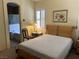 This bedroom features a neutral color scheme, a cozy chair, and plantation shutters at 4620 Ventana Rey St, North Las Vegas, NV 89081